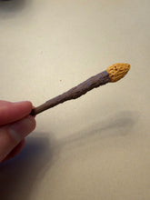 Load image into Gallery viewer, Hand holding the 3.69-inch Frogman mini wand to show its miniature size, with a brown shaft and yellow tip.
